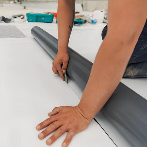 worker providing TPO roof repair or replacement services