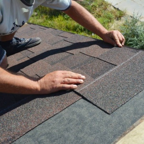 worker repairing a roof leak