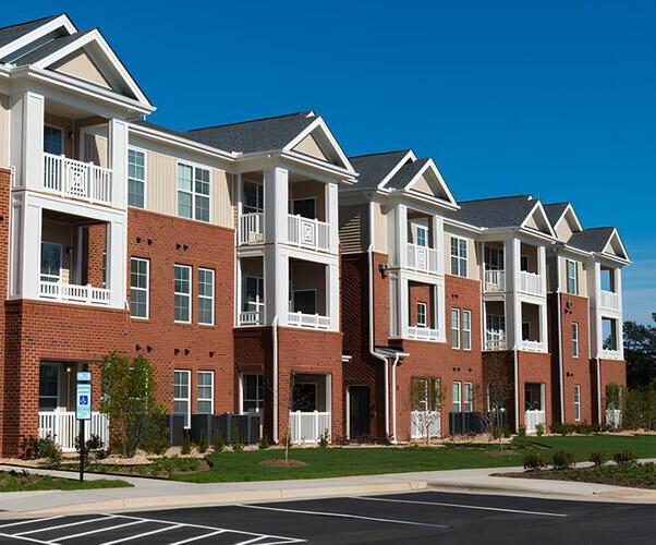row of apartment buildings with shingle roofing